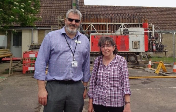Ground Source Review: Russ Fowler Director of Financial Reporting & resident Mrs Wilson in front of drilling rig
